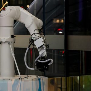 A white robotic arm operating indoors with a modern design and advanced technology.