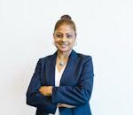 Portrait of a confident businesswoman in professional attire with a friendly smile, arms crossed.
